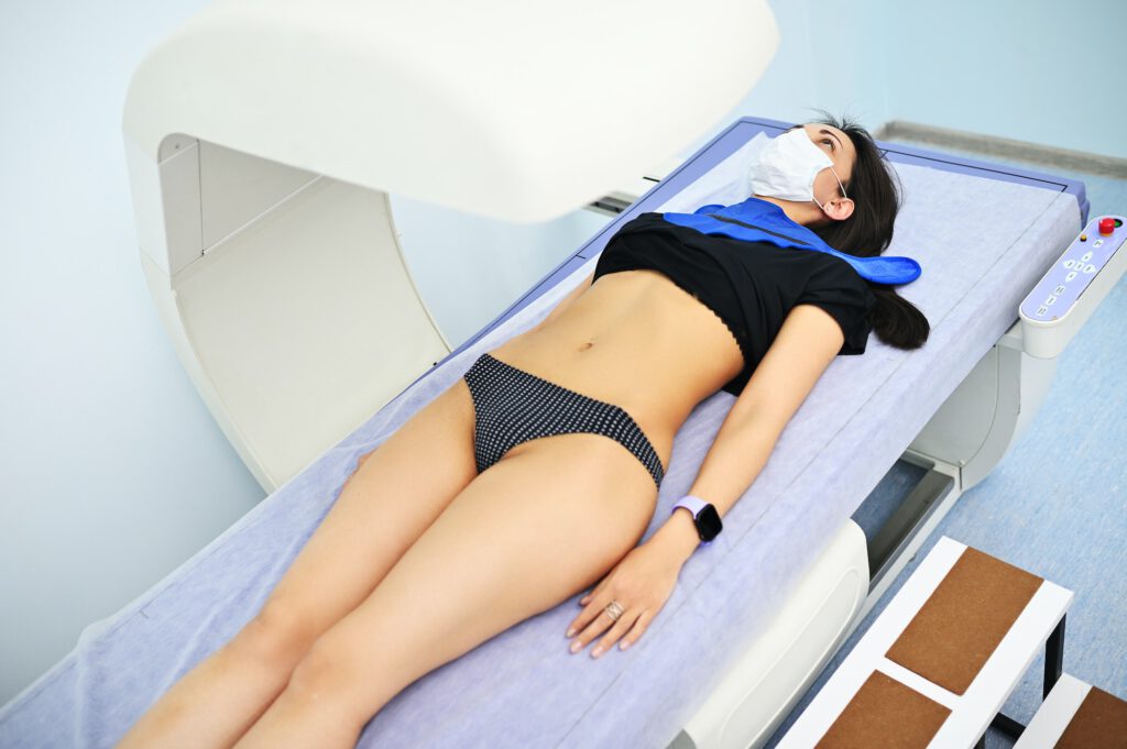 young pretty girl on examination in a modern clinic by densitometry